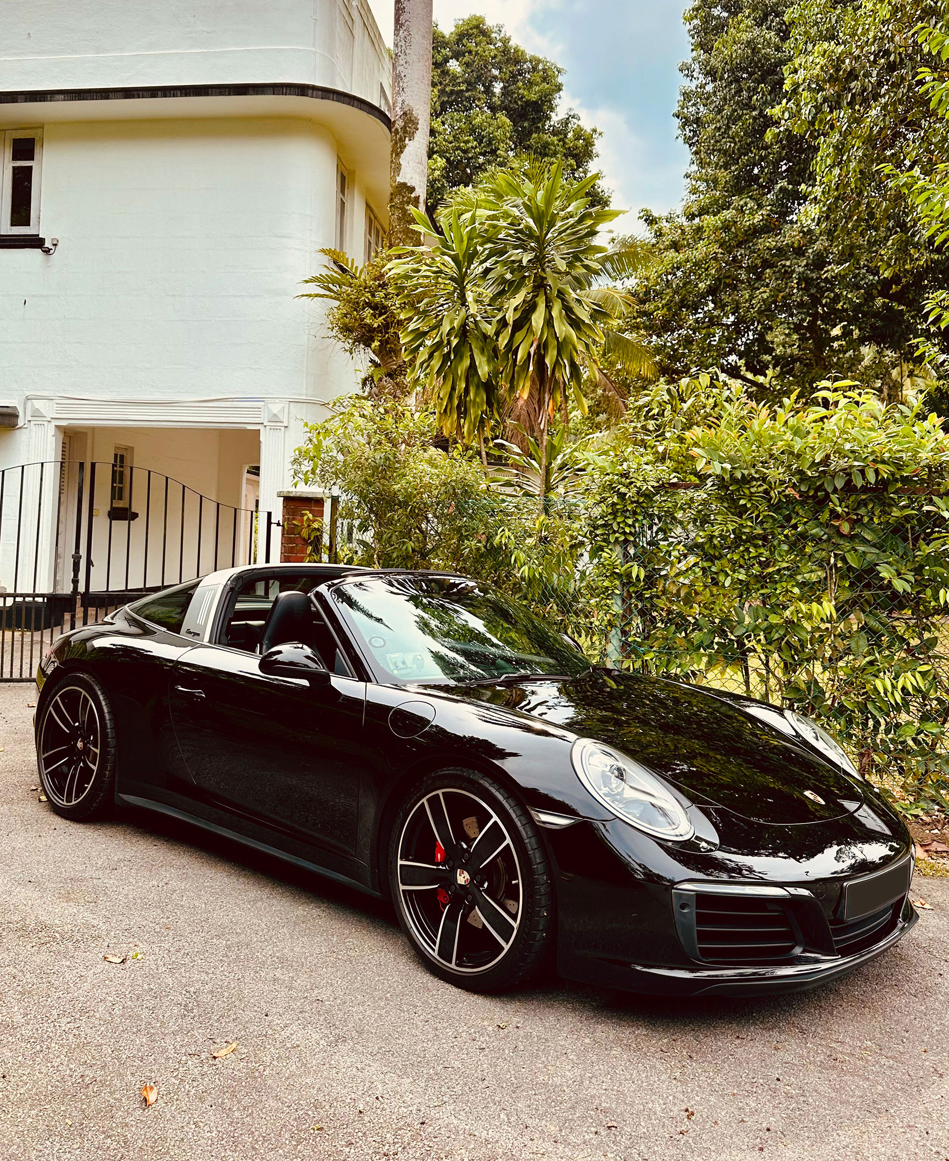 Porsche 911 in front of house